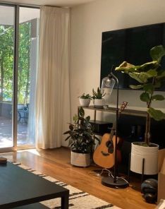 Elegant custom curtains installed on living room glass patio doors in Richmond, shown open