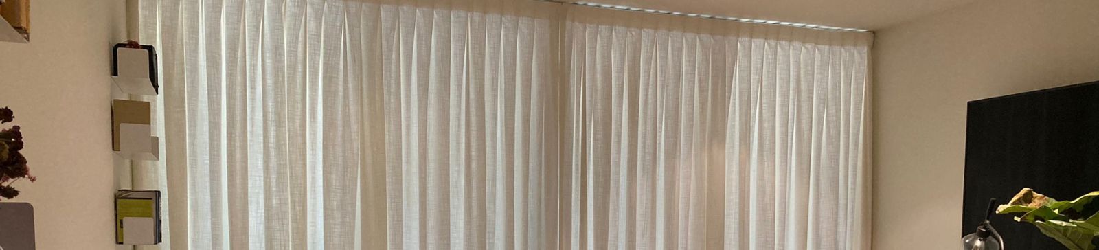Luxury curtains fully closed across wide patio glass doors in Richmond living room for privacy and elegance